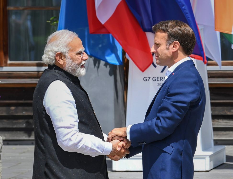 **EDS: HANDOUT PHOTO MADE AVAILABLE FROM PIB ON MONDAY, JUNE 27, 2022** Munich: Prime Minister Narendra Modi with President of France Emmanuel Macron, at G-7 Summit, in Germany. (PTI Photo)(