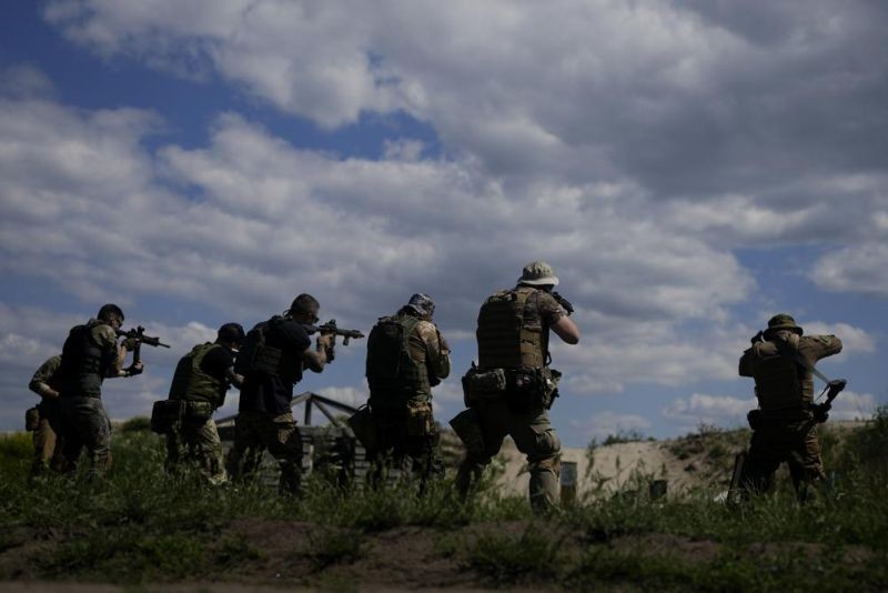 Civilian militia men hold rifles during training at a shooting range in outskirts Kyiv, Ukraine on June 7, 2022. (AP Photo)