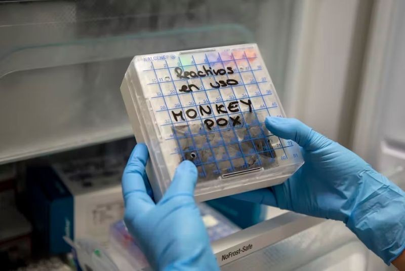 A lab technician in Spain picks up a reactive to test suspected monkeypox samples. (Photo Courtesy: Pablo Blazquez Dominguez/Getty Images)