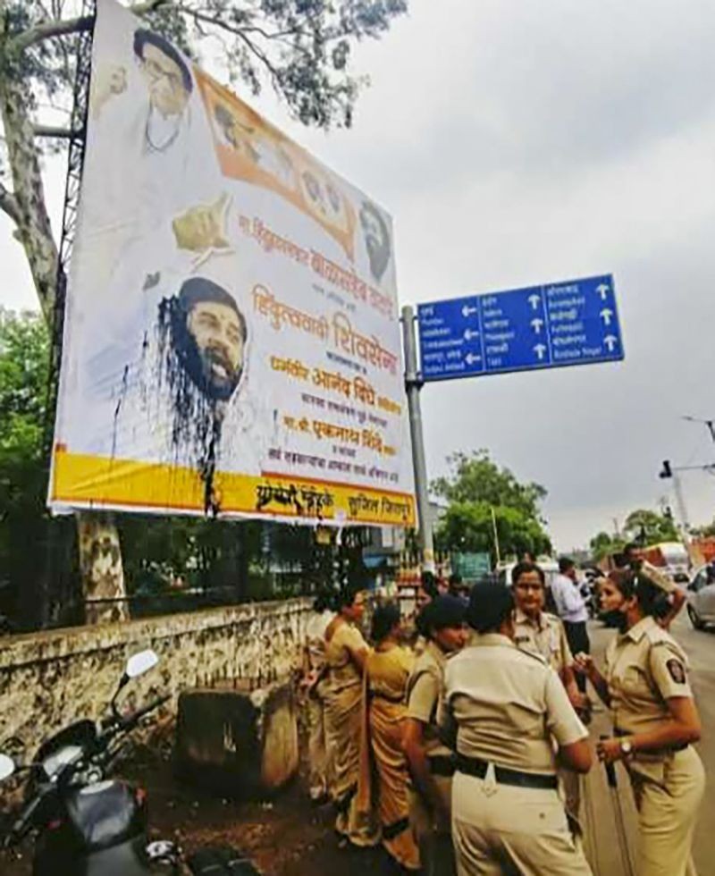 Ink throwm at rebel Shiv Sena leader Eknath Shinde's poster by Shiv Sena activists during a protest against Shinde, near Nashik on June 24, 2022. (PTI Photo)
