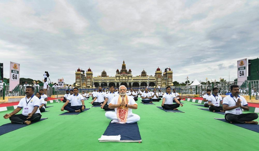Mysuru: Prime Minister Narendra Modi performs yoga at a mass yoga session to celebrate the 8th International Day of Yoga, at Mysore Palace in Mysuru, Tuesday, June 21, 2022. (PTI Photo)