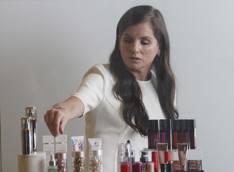 Revlon CEO Debra Perelman, the company's first woman CEO in its 89-year-old history, show products during an interview on August 18, 2021, in New York. (AP File Photo)