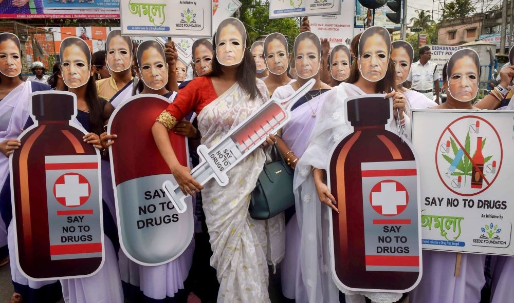 Kolkata: Women wearing facemasks of West Bengal Chief Minister Mamata Banerjee take part in an awareness rally on the International Day Against Drug Abuse & Illicit Trafficking, in Kolkata, Sunday, June 26, 2022. (PTI Photo)