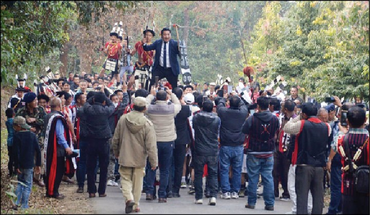 Nagaland PWD Minister Tongpang Ozukum participating at the ceremonial log carrying activity that followed the “Alisümang Liden Anempong Südok” programme at Mopungchuket village, Mokokchung on January 29. (Morung Photo)