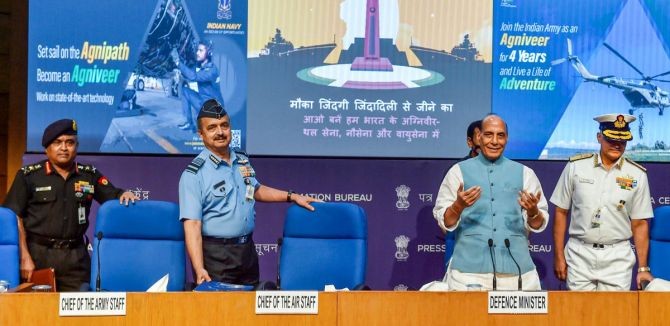 Union Defence Minister Rajnath Singh with three services' chiefs General Manoj Pande (Army), Air Chief Marshal VR Chaudhari and Admiral R Hari Kumar (Navy) at the launch of 'Agnipath' scheme at National Media Center, in New Delhi on June 14, 2022. Photograph: Manvender Vashist/PTI Photo