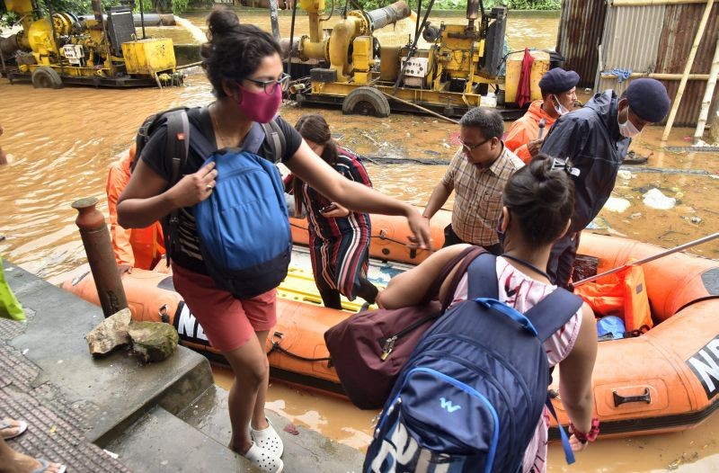 National Disaster Response Force (NDRF) personnel rescue residents from flood affected areas in Guwahati on June 14, 2022. Four people were killed in a massive landslide amid heavy rains that flooded the city. (PTI Photo)