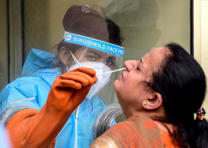 A health worker collects swab samples for the COVID-19 test in New Delhi. Photograph: Kamal Kishore/PTI Photo