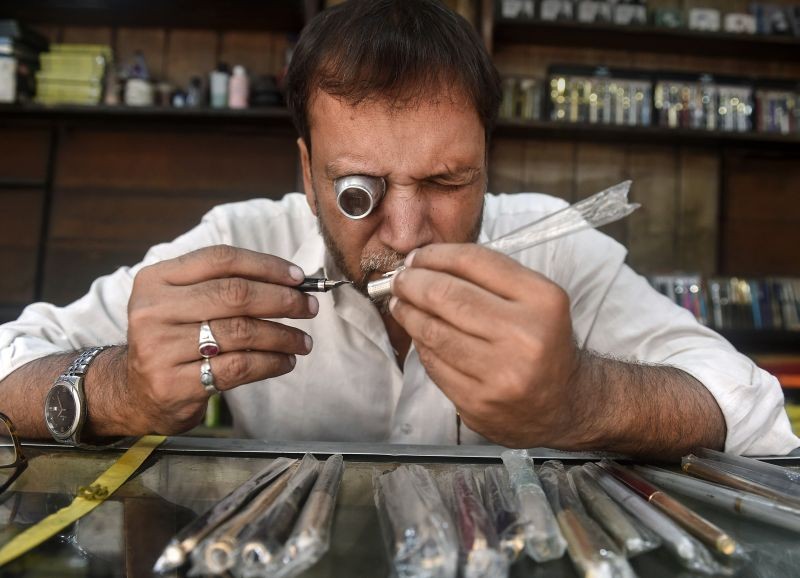 Md Imtiaz checks a pen at the 77-year-old “Pen Hospital”, where old pens are repaired and given a new life, in Kolkata on June 8, 2022. The ‘hospital’ was started by Md Imtiaz's grandfather Samsuddin, and houses several invaluable pens. When established, pen brands like Waterman, Shepherd, Pierre Carda and Wilson, cherished by the people of Kolkata, were brought here. (PTI Photo)