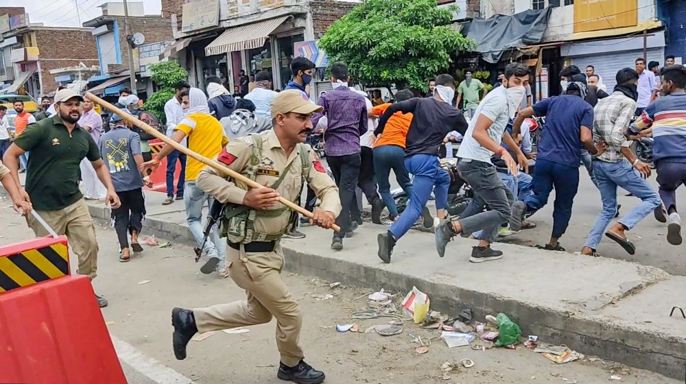 Kathua: Policemen lathi-charge people protesting against Centre's 'Agnipath' scheme, at Chadwal in Kathua district, Saturday, June 18, 2022. (PTI Photo)