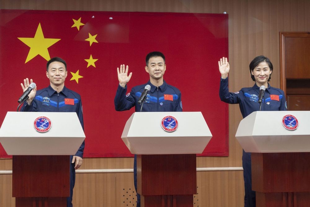 In this photo released by Xinhua News Agency, Chinese astronauts from left Cai Xuzhe, Chen Dong and Liu Yang, right, wave as they attend a press conference for the upcoming Shenzhou-14 mission at the Jiuquan Satellite Launch Center in northwestern China on Saturday, June 4, 2022. China is preparing to launch a new three-person mission to complete work on its permanent orbiting space station, the country's China Manned Space Agency said Saturday. AP/PTI