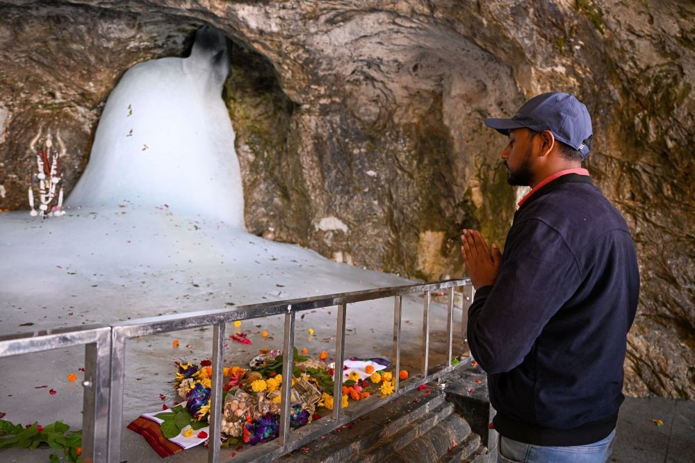 Anantnag: A devotee prays at the holy cave shrine of Amarnath during 'Pratham Pooja' in Anantnag district, Tuesday, June 14, 2022. (PTI Photo/Atul Yadav)