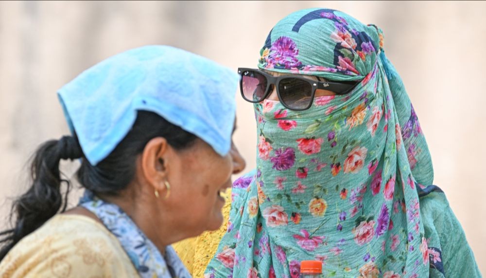 New Delhi: A woman covers her face with scarf to protect herself from the scorching heat on a hot summer day, in New Delhi, Saturday, June 4, 2022. (PTI Photo/Kamal Kishore)