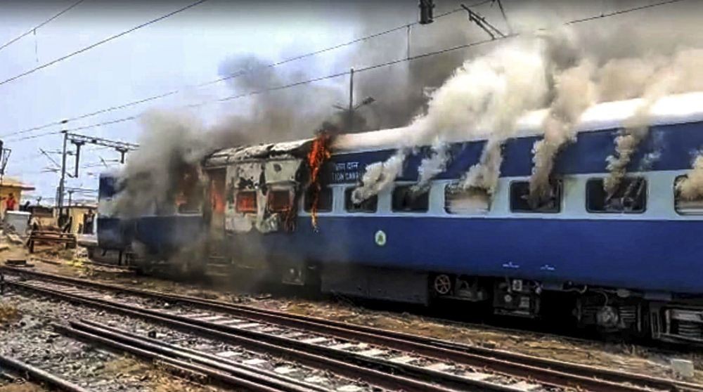 Chapra: Smoke billows out after youngsters set on fire a train in protest against the 'Agnipath' scheme at Chapra railway station, in Saran district, Thursday, June 16, 2022. (PTI Photo)