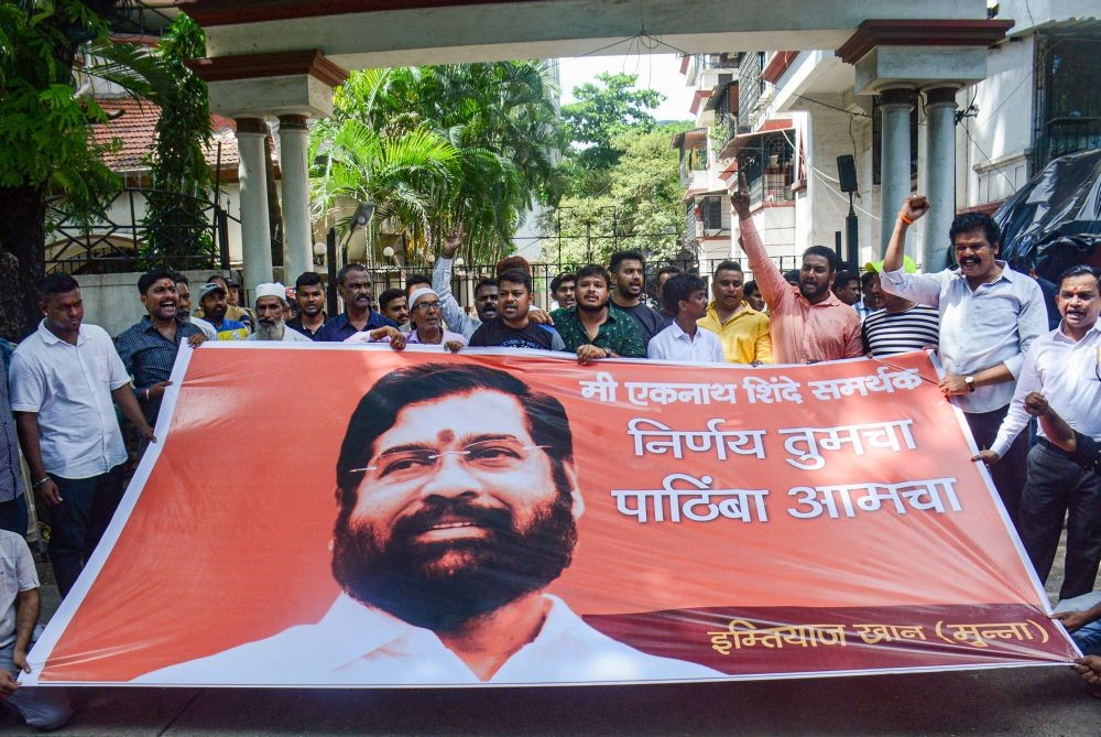 Thane: Supporters of rebel Shiv Sena leader Eknath Shinde shout slogans outside his residence in Thane, Saturday, June 25, 2022. (PTI Photo)