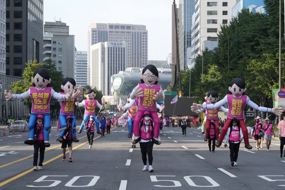Members of the Korean Confederation of Trade Unions march during a rally against the government's labor policy in Seoul, South Korea, Saturday, July 2, 2022. Thousands of workers rallied to demand better working conditions and expanding labor rights. The signs read, "Elimination of temporary workers." AP/PTI