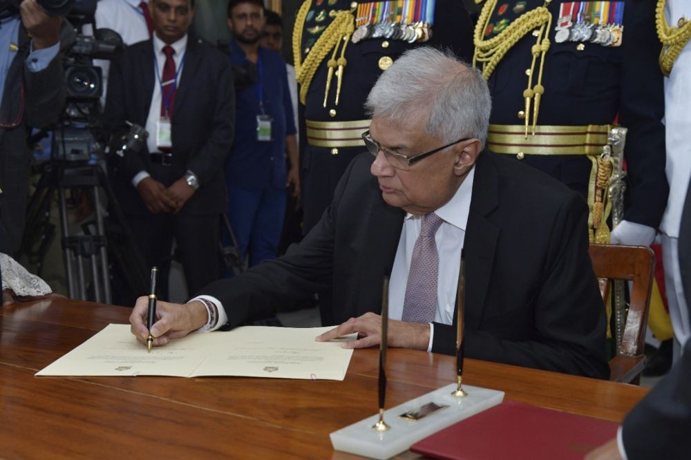 In this photo provided by Sri Lankan President's Office, Sri Lanka's newly elected president Ranil Wickremesinghe, signs after taking oath during his swearing in ceremony in Colombo, Sri Lanka, Thursday, July 21, 2022. AP/PTI
