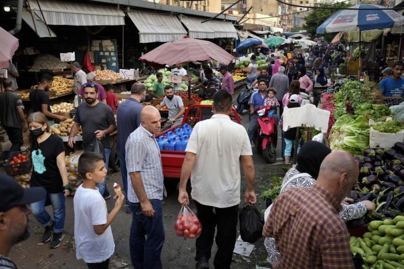 People shop at a busy popular market in Beirut, Lebanon on July 15, 2022. (AP File Photo)