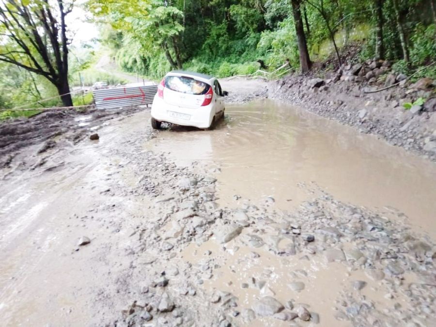 A vehicle manoeuvres through a waterlogged pothole on the National Highway (NH) 2 from Khuzama to Kigwema and Phesama stretch. (Morung Photo)
