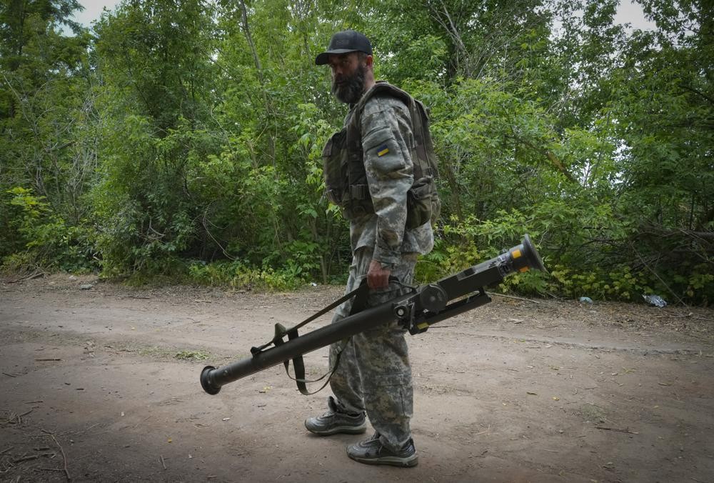 FILE - A Ukrainian soldier carries a U.S.-supplied Stinger as he goes along the road, in Ukraine's eastern Donetsk region, June 18, 2022. The deliveries of Western weapons have been crucial for Ukraine's efforts to fend off Russian attacks in the country's eastern industrial heartland of Donbas. (AP Photo/Efrem Lukatsky, File)