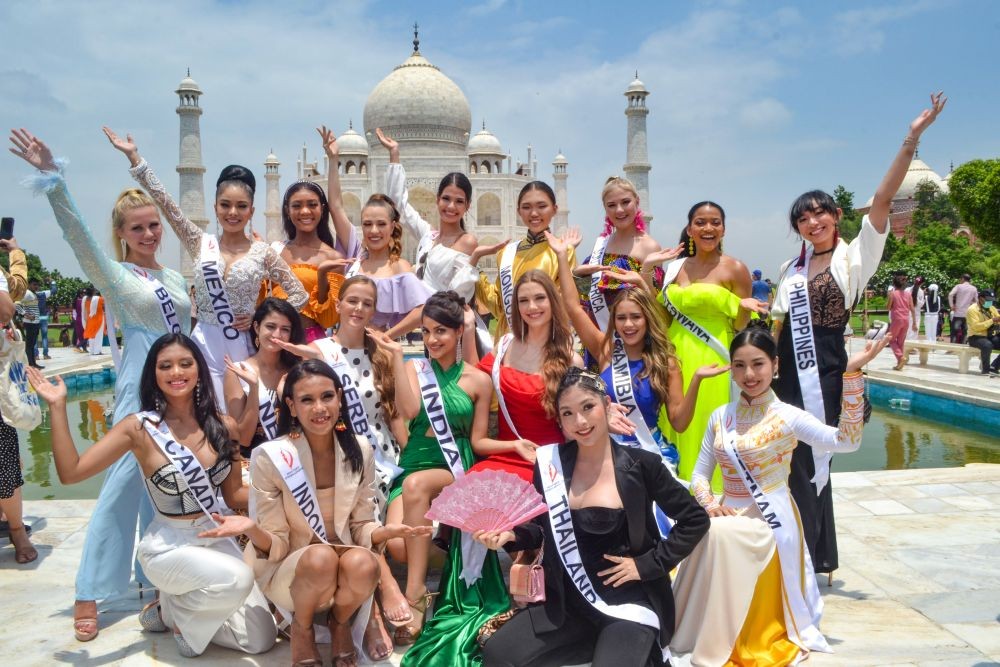 Agra: Miss Teen International participants pose for photographs at the Taj Mahal complex, in Agra, Monday, July 25, 2022. (PTI Photo)
