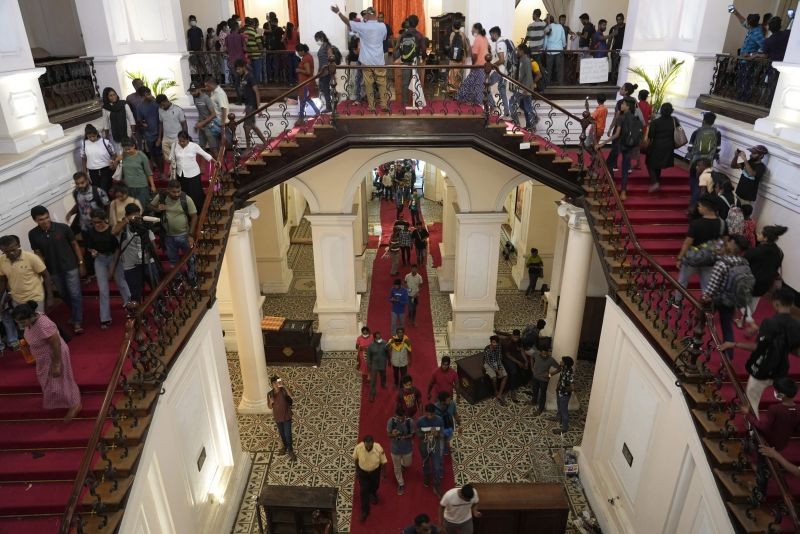 People arrives at the official residence of president Gotabaya Rajapaksa fourth days after it was stormed by anti government protesters in Colombo in Colombo, Sri Lanka on Wednesday, July 13, 2022. The president of Sri Lanka fled the country early Wednesday, days after protesters stormed his home and office and the official residence of his prime minister amid a monthslong economic crisis that triggered severe shortages of food and fuel. (AP/PTI Photo)