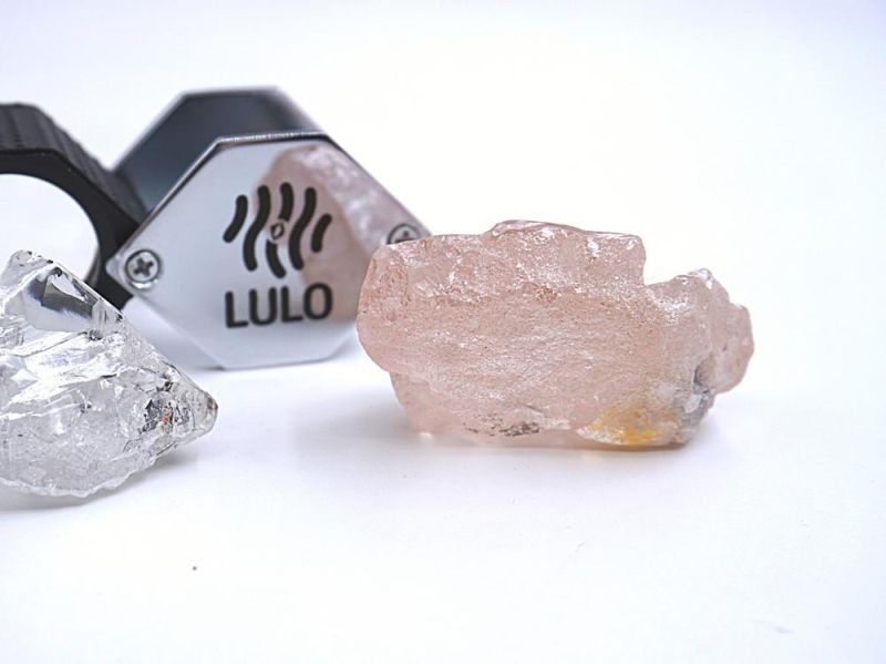 This photo supplied by Lucapa Diamond Company on Wednesday, July 27, 2022, shows the 170 carat pink diamond, right, recovered from Lulo, Angola. A big pink diamond of 170 carats has been discovered in Angola and is claimed to be the largest such gemstone found in 300 years. Called the “Lulo Rose,” the diamond was found at the Lulo alluvial diamond mine. The mine’s owner, the Lucapa Diamond Company, on Wednesday announced the discovery of the large pink diamond on its website. (AP Photo)