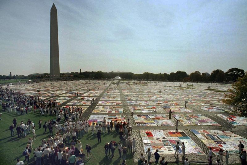 People visit the 21,000 panel Names Project AIDS Memorial Quilt in Washington on Saturday, Oct. 10, 1992. (AP File Photo)