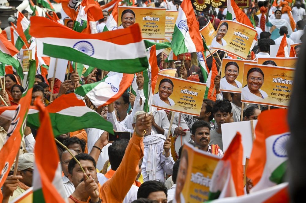 New Delhi: BJP workers and supporters celebrate NDA's presidential candidate Droupadi Murmu's lead during counting of votes to elect the 15th President, in New Delhi, Thursday, July 21, 2022. (PTI Photo/Ravi Choudhary)