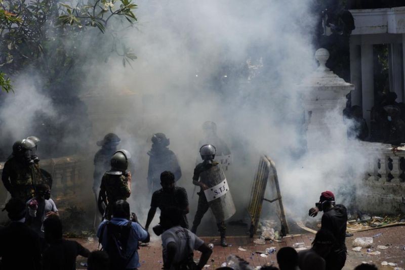 Police use teargas as Sri Lankan protesters storm the compound of prime minister Ranil Wickremesinghe 's office, demanding he resign after president Gotabaya Rajapaksa fled amid economic crisis in Colombo, Sri Lanka, Wednesday, July 13, 2022. (AP Photo)