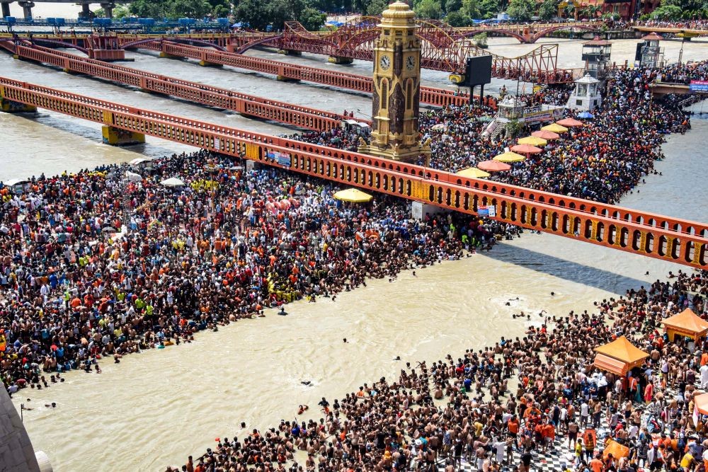Haridwar: Kanwariyas (Lord Shiva devotees) gather at the Har Ki Pauri ghat to collect holy water from the Ganga river for their pilgrimage during the month of 'Shravan', in Haridwar, Monday, July 25, 2022. (PTI Photo)(
