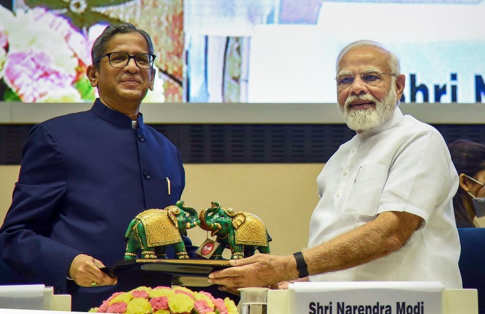 New Delhi: Prime Minister Narendra Modi receives a memento from Chief Justice of India N.V. Ramana during the inaugural session of First All India District Legal Services Authorities Meet, at Vigyan Bhawan in New Delhi, Saturday, July 30, 2022. (PTI Photo/Shahbaz Khan)