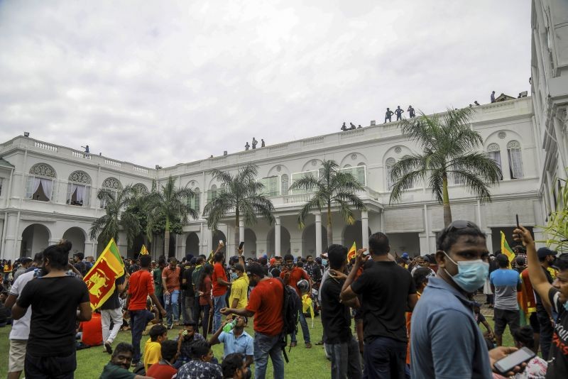 Protesters gather inside the premises of Sri Lankan presidents official residence in Colombo, Sri Lanka on July 9, 2022. Sri Lankan protesters demanding that President Gotabaya Rajapaksa resign forced their way into his official residence on Saturday, a local television report said, as thousands of people took to the streets in the capital decrying the island nation's worst economic crisis in recent memory. (AP/PTI Photo)