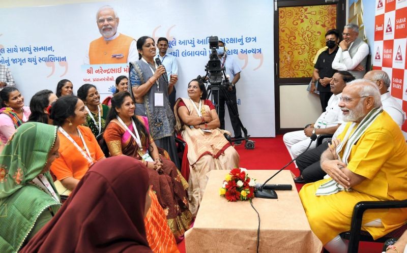 Prime Minister Narendra Modi interacts with women during his visit to the Sabar Dairy, in Gujarat's Sabarkantha district, Thursday, July 28, 2022. (PTI Photo)