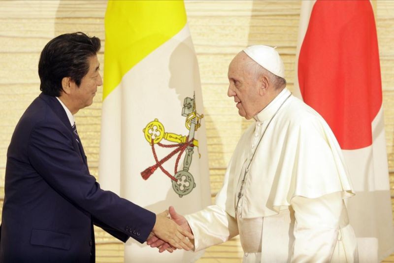 Pope Francis, right, shake hands with Japanese Prime Minister Shinzo Abe after speaking to Authorities and the Deplomatic Corps at the Kantei on November 25, 2019, in Tokyo. Pope Francis is praying that Japan will strengthen its commitment to peace and nonviolence despite the “senseless” assassination of former Prime Minister Shinzo Abe, the Vatican said Saturday, July 9, 2022. (AP File Photo)