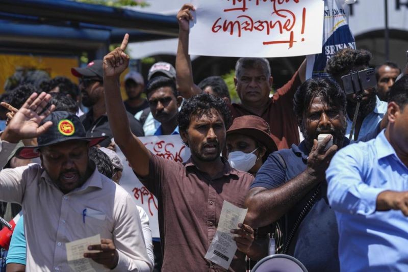 Trade Union activists and civil society members shout slogans against Acting President and Prime Minister Ranil Wickremesinghe as lawmakers prepare to elect a new president in Colombo, Sri Lanka, Tuesday, July 19, 2022. The protestors demanded Wickremesinghe be ousted and prevented from being elected as the successor to Gotabaya Rajapaksa who fled the country last week. (AP Photo)