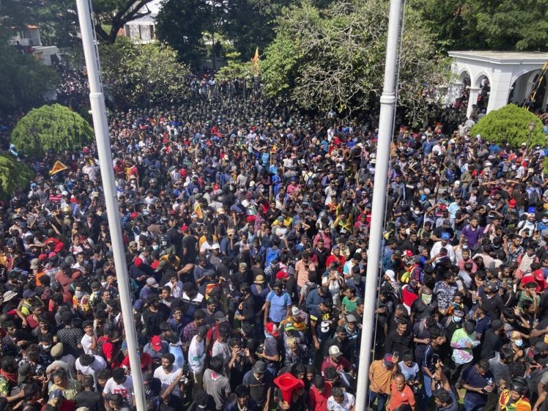 Sri Lankan protesters storm the compound of prime minister Ranil Wickremesinghe 's office, demanding he resign after president Gotabaya Rajapaksa fled amid economic crisis in Colombo, Sri Lanka, Wednesday, July 13, 2022. (AP Photo)