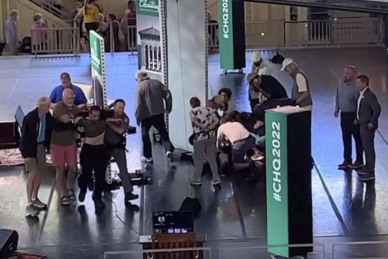 This still image from video shows Hadi Matar, 24, of Fairview, N.J., at left, being escorted from the stage as people tend to author Salman Rushdie, center right, at the Chautauqua Institution, in Chautauqua, NY, on August 12, 2022. Salman Rushdie, the author whose writing led to death threats from Iran in the 1980s, was attacked and apparently stabbed in the neck Friday by Matar who rushed the stage as he was about to give a lecture in western New York. (AP Photo)