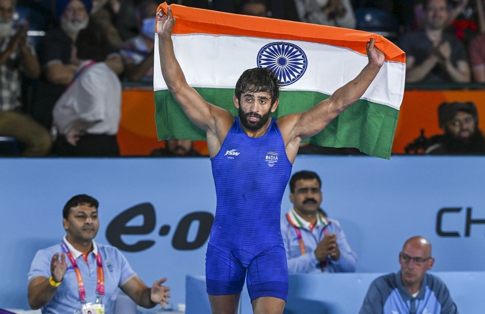 Birmingham: India's Bajrang Punia holds the tricolor after winning against Canada's Lachlan McNeil in the final of the Men's Freestyle Wrestling 65kg category event, at the Commonwealth Games 2022 (CWG), in Birmingham, UK, Friday, Aug. 5, 2022. Punia won the gold medal (PTI Photo/Swapan Mahapatra)(