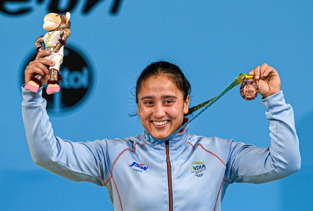 Birmingham: India's Harjinder Kaur atop the podium poses for photographs after winning the bronze medal in the women's 71kg category weightlifting event, at the Commonwealth Games 2022 (CWG), in Birmingham, UK, Monday, Aug. 1, 2022. (PTI Photo/Swapan Mahapatra)