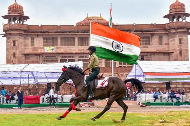 A NCC cadet mounted on a horse holds the tricolor during full dress rehearsal for the 76th Independence Day, in Bikaner on August 13, 2022. (PTI Photo)