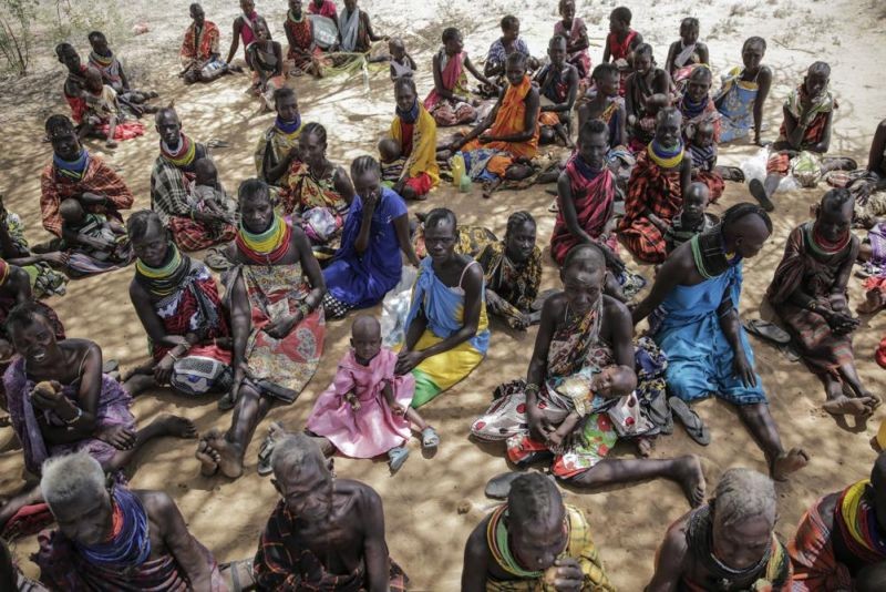 Villagers gather during a visit by United Nations Under-Secretary-General for Humanitarian Affairs Martin Griffiths, in the village of Lomoputh in northern Kenya, May 12, 2022. Griffiths visited the area on Thursday to see the effects of the drought which the U.N. says is a severe climate-induced humanitarian emergency in the Horn of Africa. More than 50 million people in the wider East African region are expected to face acute food insecurity this year, a regional bloc said Friday July 22, 2022, warning that some 300,000 in Somalia and South Sudan are projected to be under full-blown famine conditions. (AP File Photo)