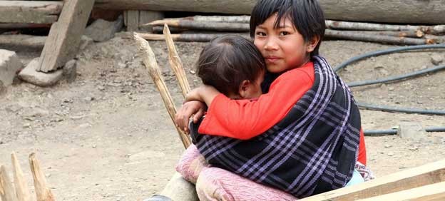 A child looks after his younger sibling in Myanmar. Myanmar’s military junta is responsible for shocking violence against children caught up in the bloody aftermath of last February’s coup, a top independent Human Rights Council-appointed investigator said in June 2022. The United Nations Children's Fund (UNICEF) has reported that landmines and unexploded ordnance have maimed or killed children in many regions of the country, with the highest casualty rate in Shan State in northeast Myanmar. (Photo Courtesy: World Bank/Tom Cheatham)