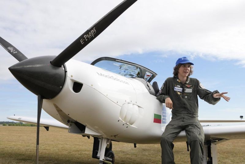 Seventeen year old Anglo-Belgian pilot, Mack Rutherford, speaks with the media after landing at the Buzet airfield in Pont-A-Celles, Belgium, Tuesday, Aug. 23, 2022. Rutherford landed in Belgium before flying on to Slovakia and Sofia, Bulgaria, for the final leg of his Guinness World Record attempt to be the youngest person to the fly around the world solo in a small plane. (AP Photo)