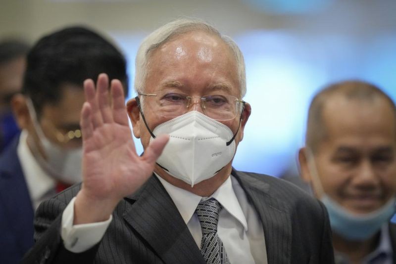 Former Malaysian Prime Minister Najib Razak, center, wearing a face mask arrives at Court of Appeal in Putrajaya, Malaysia, Tuesday, Aug. 16, 2022. Malaysia's top court Monday began hearing a final appeal by Najib to toss out his graft conviction linked to the massive looting of the 1Malaysia Development Berhad state fund. (AP Photo)