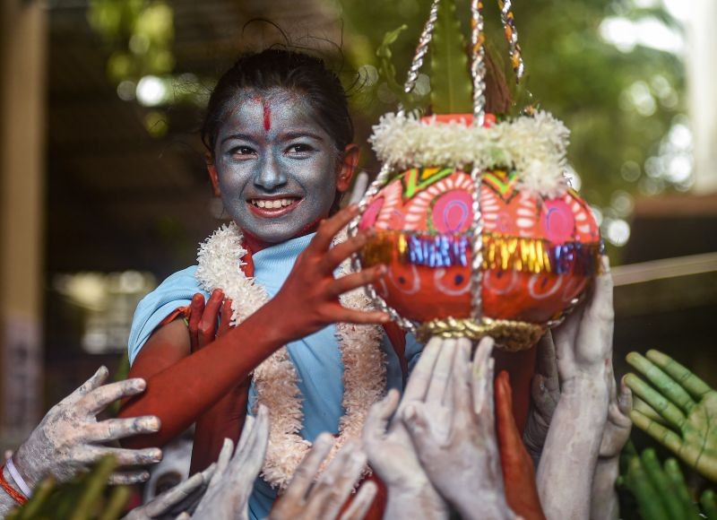 Students form a human pyramid to break the 'dahi handi' during 'Janmashtami' festival celebrations, at Shreemati Nathibai Damodar Thackersey (SNDT) College, in Mumbai on August 17, 2022. (PTI Photo)