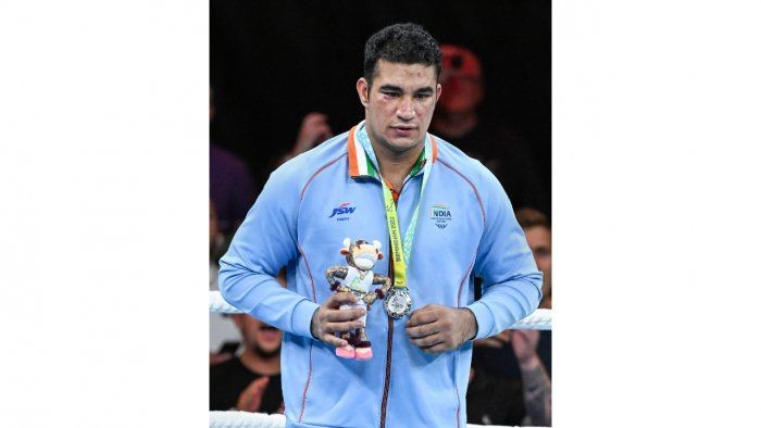 Silver medallist boxer Sagar Ahlawat poses for photographs during the 92kg (Super Heavyweight) category medal ceremony, at the Commonwealth Games 2022. Credit: PTI Photo