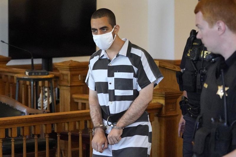 Hadi Matar, 24, center, arrives for an arraignment in the Chautauqua County Courthouse in Mayville, NY., Saturday, Aug. 13, 2022. Matar, the man charged with stabbing Salman Rushdie on a lecture stage in western New York on Friday, Aug. 12 said in an interview that he was surprised to learn the accomplished author had survived the attack. (AP File Photo)
