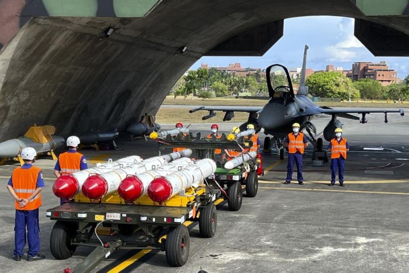 Military personnel stand next to Harpoon A-84, anti-ship missiles and AIM-120 and AIM-9 air-to-air missiles prepared for a weapon loading drills in front of a F16V fighter jet at the Hualien Airbase in Taiwan's southeastern Hualien county on Wednesday, Aug. 17, 2022. Taiwan is staging military exercises to show its ability to resist Chinese pressure to accept Beijing's political control over the island. (AP Photo)