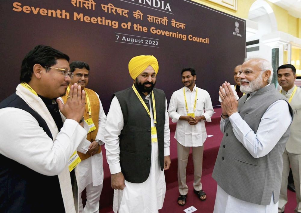 **EDS: IMAGE VIA PMOIndia** New Delhi: Prime Minister Narendra Modi exchanges greetings with Meghalaya CM Conrad Sangma and MP CM Shivraj Singh Chouhan at the 7th Governing Council meeting of NITI Aayog at Rashtrapati Bhawan Cultural Centre, in New Delhi, Sunday, Aug 7, 2022. (PTI Photo)