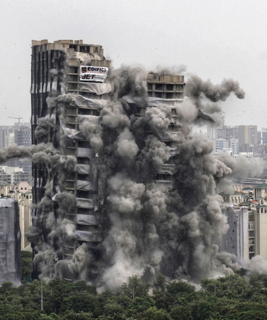 Noida: A view of the Supertech's twin towers being demolished with the use of 3,700 kg explosives in compliance with a Supreme Court order, in Noida on Sunday, Aug 28, 2022. (Photo:Wasim Sarvar /IANS